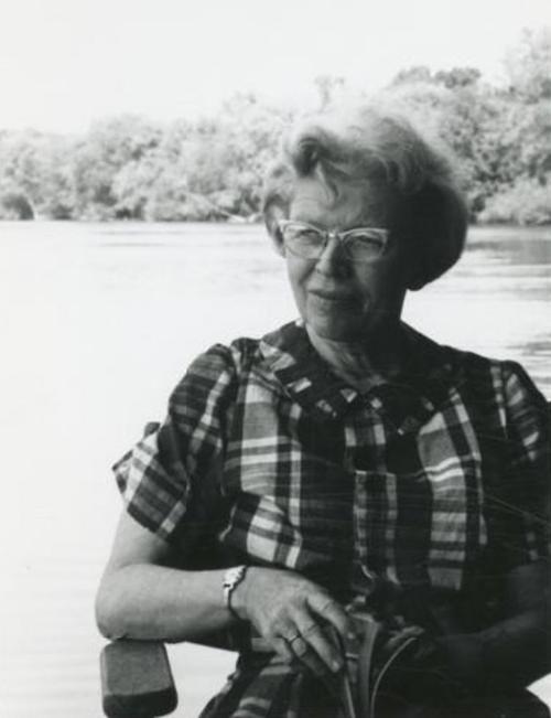 Lorine Niedecker sitting by a river.