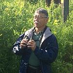 Ken Yasukawa observing birds in the field.